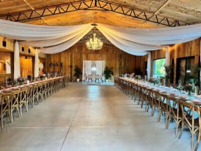 Rustic Grace Barn, wedding venue, indoor pavilion, reception, white material hanging from the ceiling, long tables, Orlando, FL