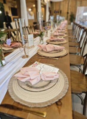 close up of a place setting, pink napkins, white runner, candles, Orlando, FL