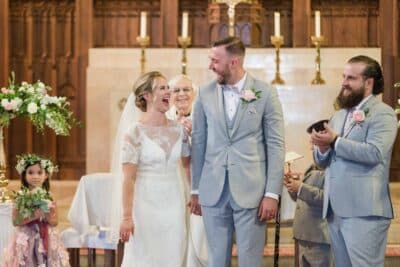 bride and groom after the ceremony concluded, best man by their side and flower girl behind them, H Hawkins Photography, Orlando, FL