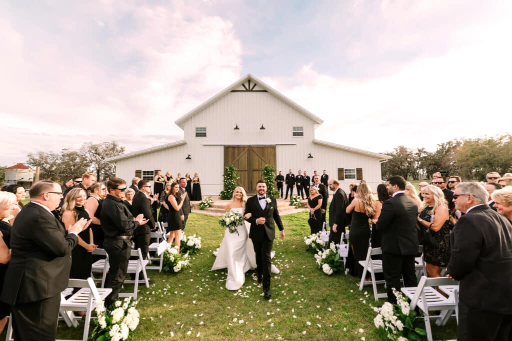 bride and groom walking out of the chapel at Legacy at Oak Meadows, Orlando, FL