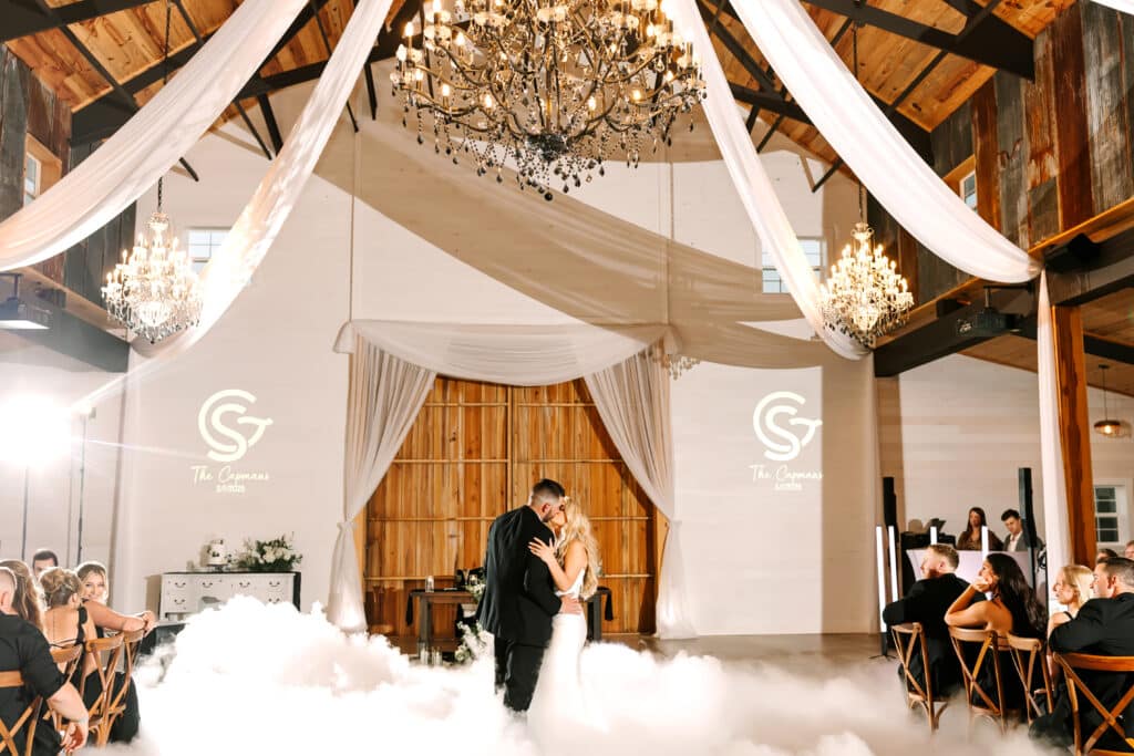 bride and groom dancing on the dance floor, wedding reception, large pavilion, fog on the floor, Orlando, FL