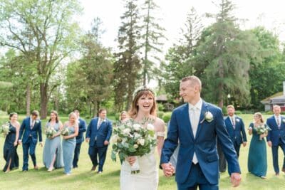 bride and groom in the foreground, wedding party in the background, varying shades of blue for suits and dresses, Orlando, FL