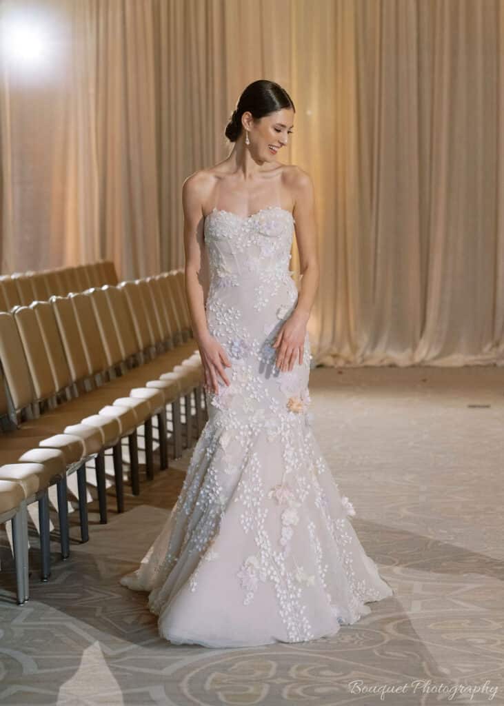 Stunning beaded wedding dress with bride wearing a low bun.