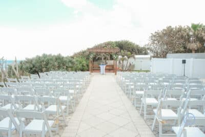 outdoor wedding ceremony, rows of white chairs, large wooden altar, patio, Orlando, FL