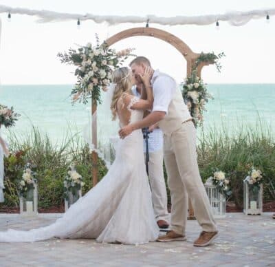 bride and groom kissing at the altar, outdoors, Crowne Plaza Melbourne Oceanfront, Orlando, FL