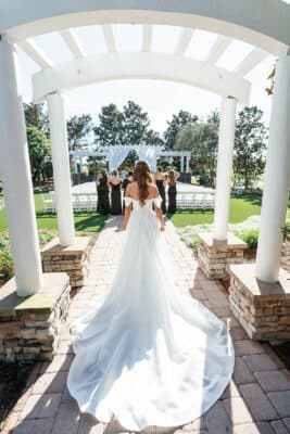 bride in her wedding gown, looking out to the set up for the ceremony, The Royal Crest Room, Orlando, FL