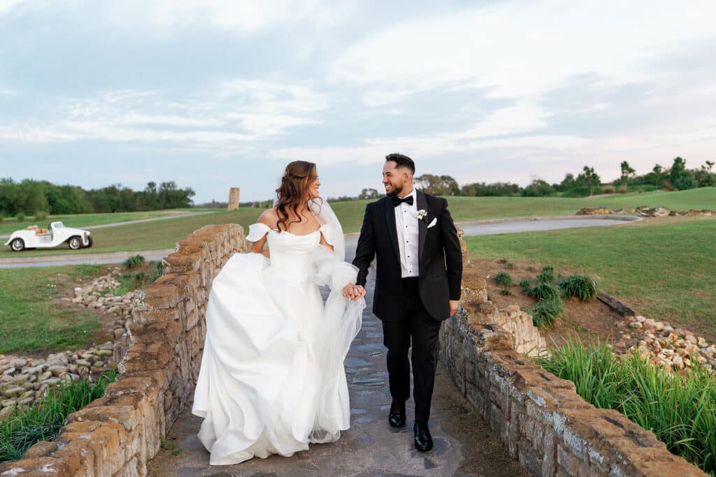 bride and groom walking along the stone bridge, countryside, Orlando, FL