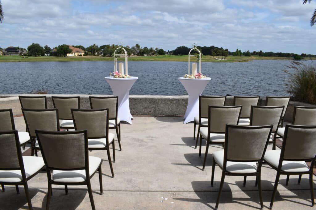 outdoor altar set up, chairs set up for a wedding ceremony, waterfront, large palm tree, Orlando, FL