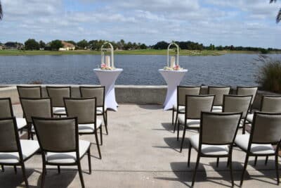 outdoor altar set up, chairs set up for a wedding ceremony, waterfront, large palm tree, Orlando, FL