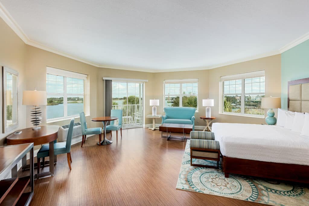 suite at the Waterfront Inn, king bed, large windows facing the water, Orlando, FL