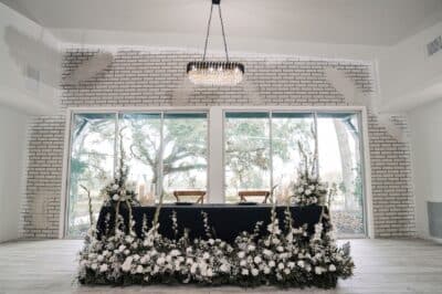 wedding reception, head table, black tablecloth, white floral arrangement at the foot of the table, Orlando, FL