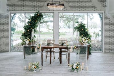 head table, white florals, greenery around the arch, Orlando, FL