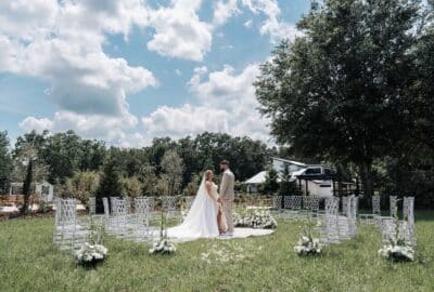 bride and groom standing together at the center of the wedding ceremony set up, chairs in a circular arrangement around them, Orlando, FL