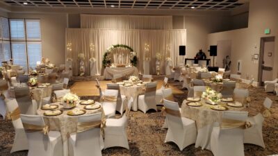 wedding reception set up, round tables, white tablecloths, white chairs with gold ribbons, gold chargers, Rosen Bella Vista, Rosen Inn Lake Buena Vista, Orlando, FL