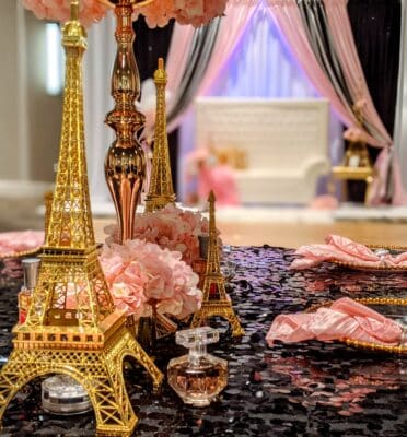 gold Eiffel Tower, gold lamp, pink napkins, perfume bottles, table centerpieces, Orlando, FL