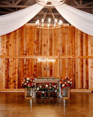 wedding reception, head table, surrounded by flowers, wood wall, white fabric on ceiling, Orlando, FL