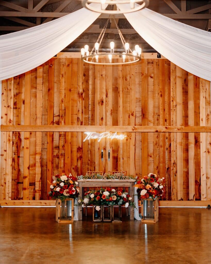 wedding reception, head table, surrounded by flowers, wood wall, white fabric on ceiling, Orlando, FL