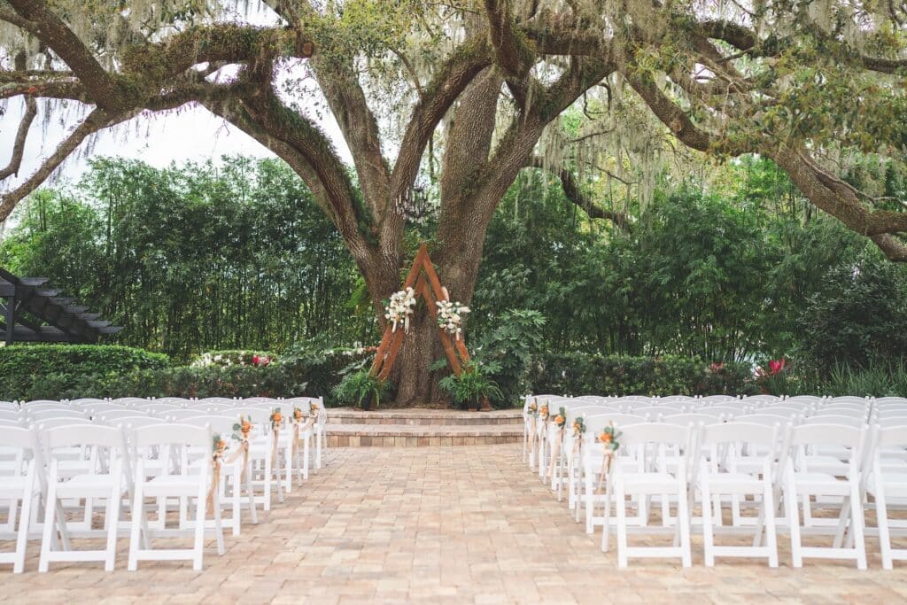 wedding ceremony, outdoors, large tree, white chairs, Orlando, FL