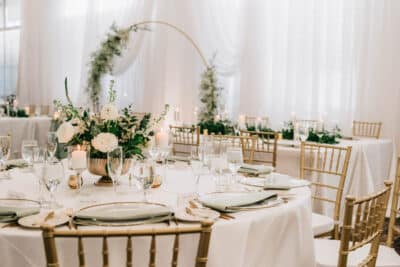 wedding reception set up, round table, round arch with greenery, white tablecloths, Orlando, FL