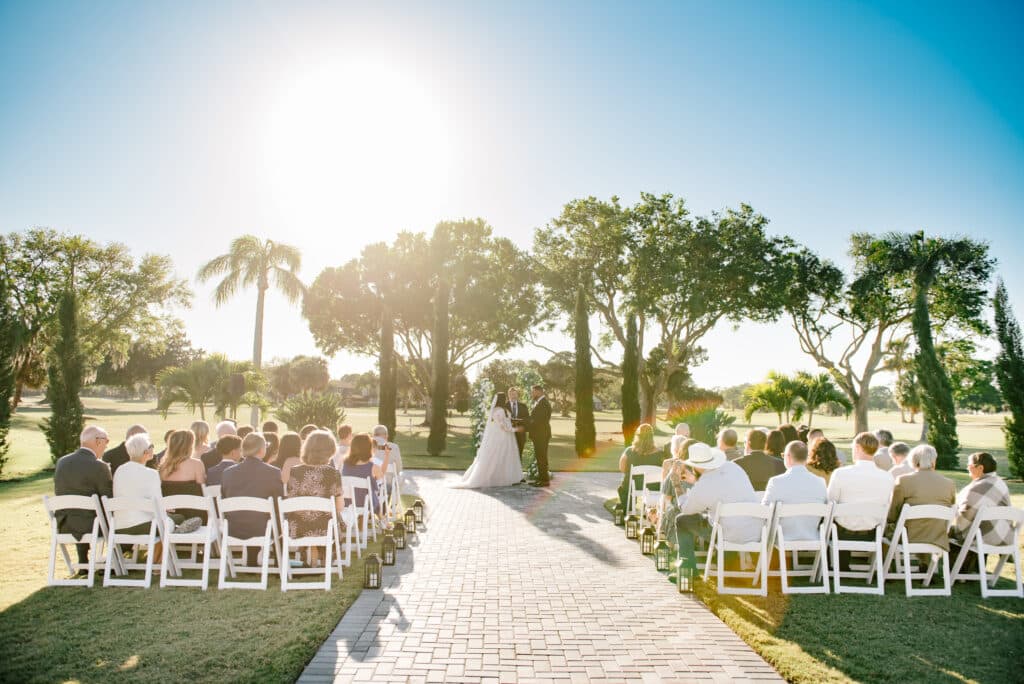 wedding ceremony, outdoors, white chairs, sunset, bride and groom at the altar, Rockledge Country Club, Orlando, FL