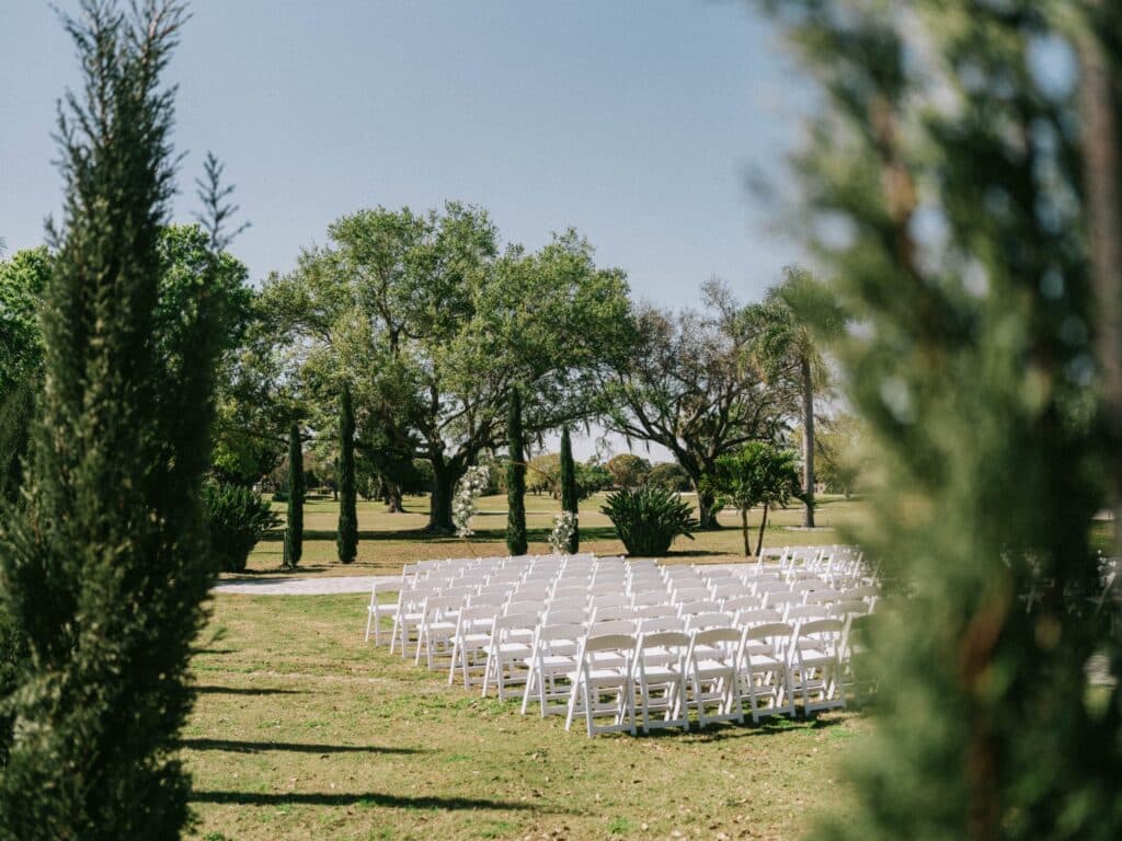 outdoor wedding ceremony, white chairs, Rockledge Country Club, Orlando, FL