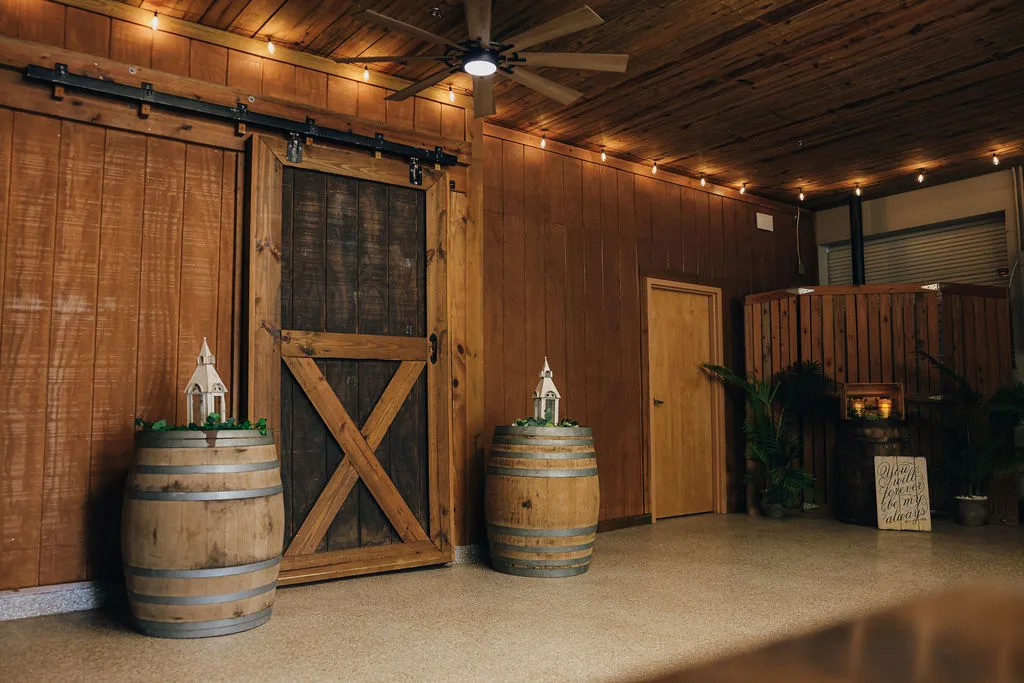The Lower Barn at The Ranch at St. Cloud features authentic rustic details, including sliding barn doors that connect directly to the main reception space. This area supports event flow and functionality, often used for catering prep and behind-the-scenes operations, while maintaining the cohesive aesthetic of the venue.