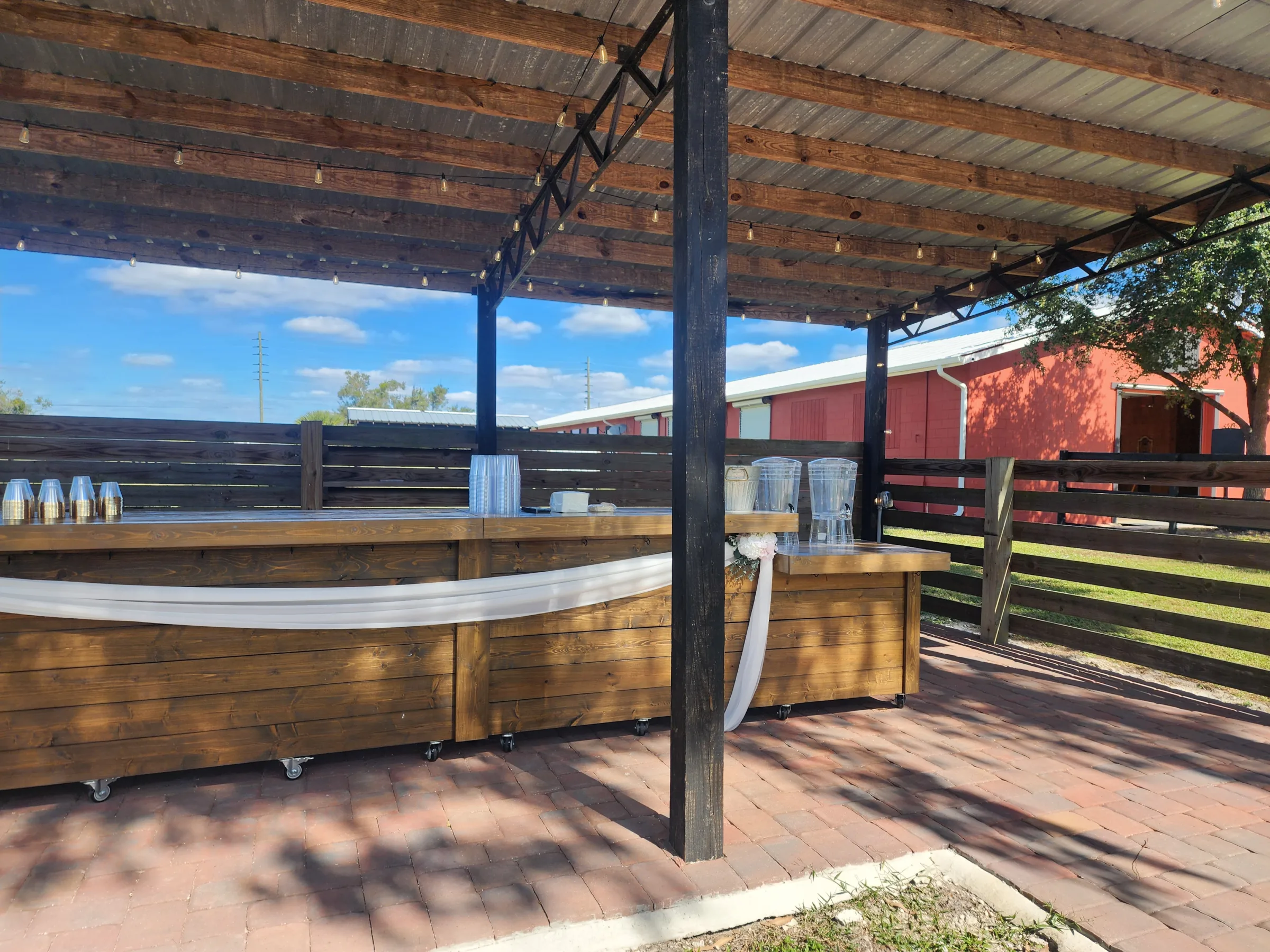 Outdoor pavilion bar at The Ranch at St. Cloud with wooden bar setup, covered structure, and service area for weddings.