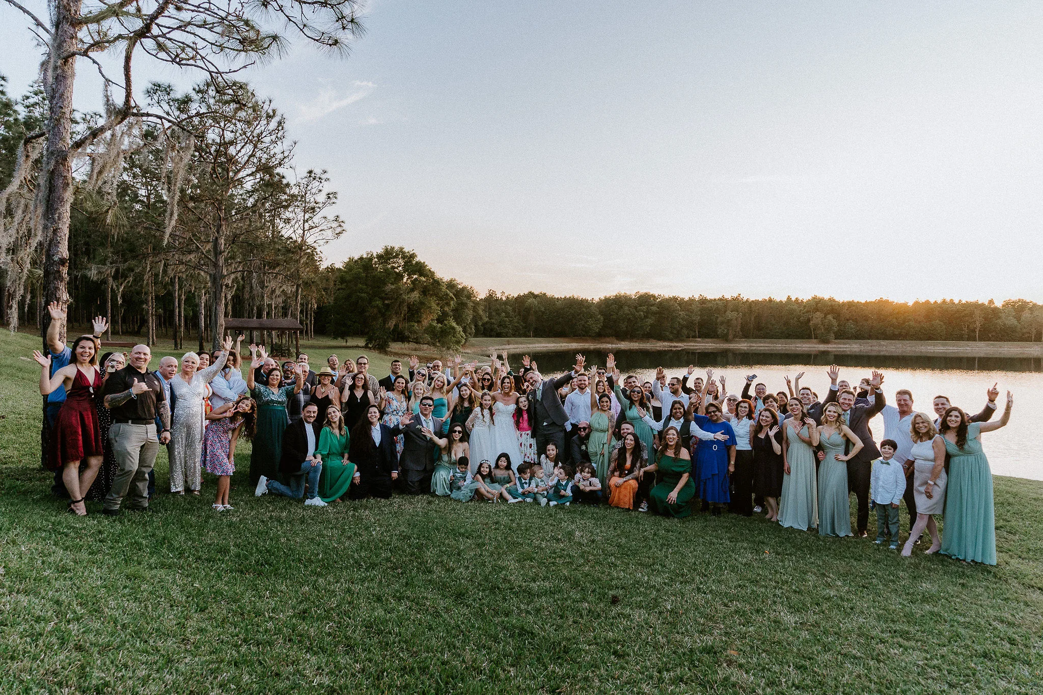 DSC00787 - Wedding Venue Shopping Tips Every Newly Engaged Couple Should Know large group of wedding guests gathered outdoors by a lake at sunset, example for wedding venue shopping tips for big guest counts