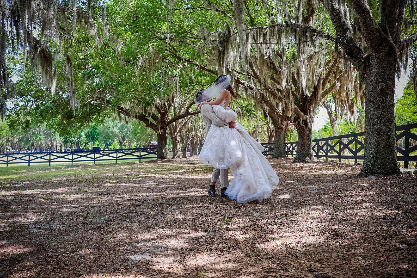 3F1A4121 - Organic Wedding Inspiration for Your Central Florida Wedding Groom carrying bride with a woodsy background at the Autumn Hill Venue, posing for their Organic wedding inspiration styled shoot.