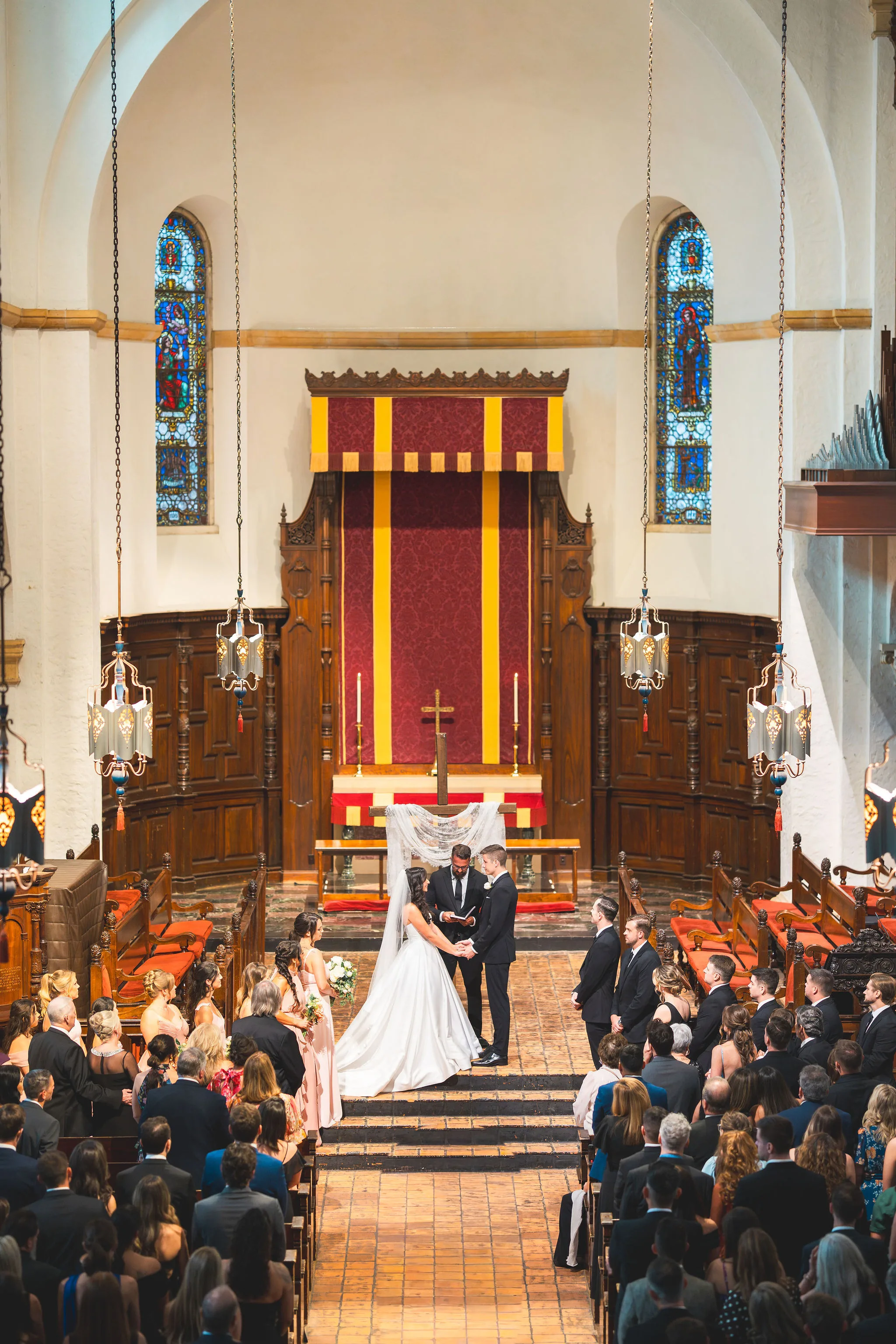 CodyKarinaWedding03.15.2026 538 - European Inspired Wedding | Rollins College Wedding ceremony inside Knowles Chapel at Rollins College with stained glass windows and couple at the altar