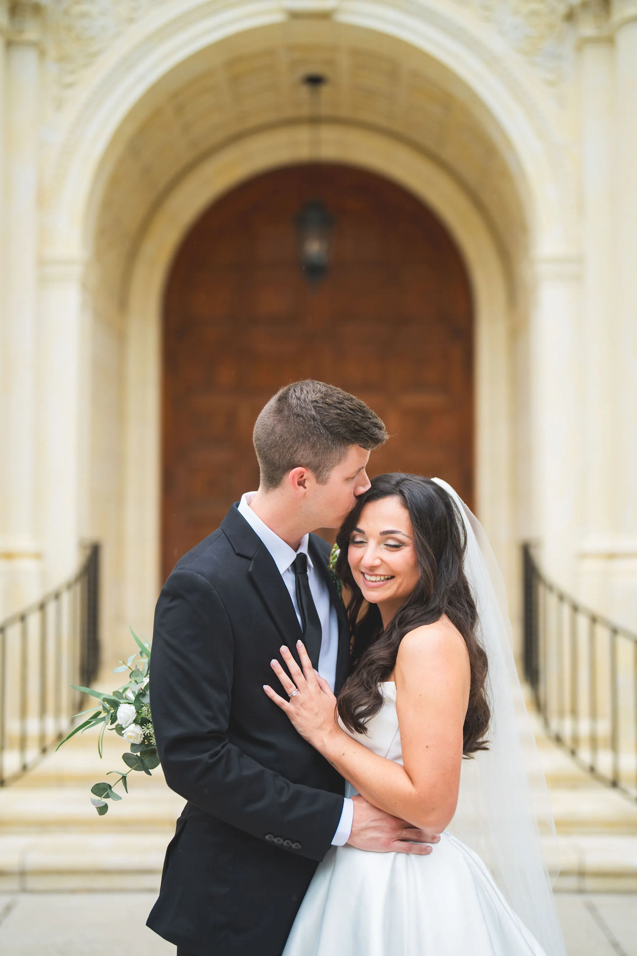 CodyKarinaWedding03.15.2026 707 - European Inspired Wedding | Rollins College Bride and groom portrait outside the entrance of Knowles Chapel at Rollins College