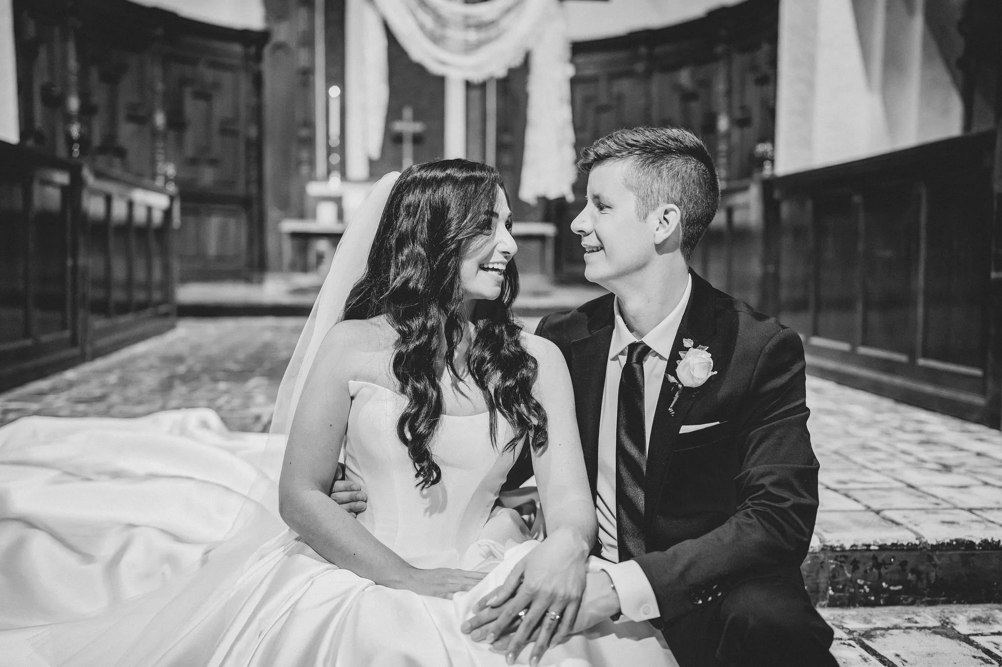 CodyKarinaWedding03.15.2026 803 - European Inspired Wedding | Rollins College Bride and groom sitting on chapel steps laughing together at their Rollins College european inspired wedding