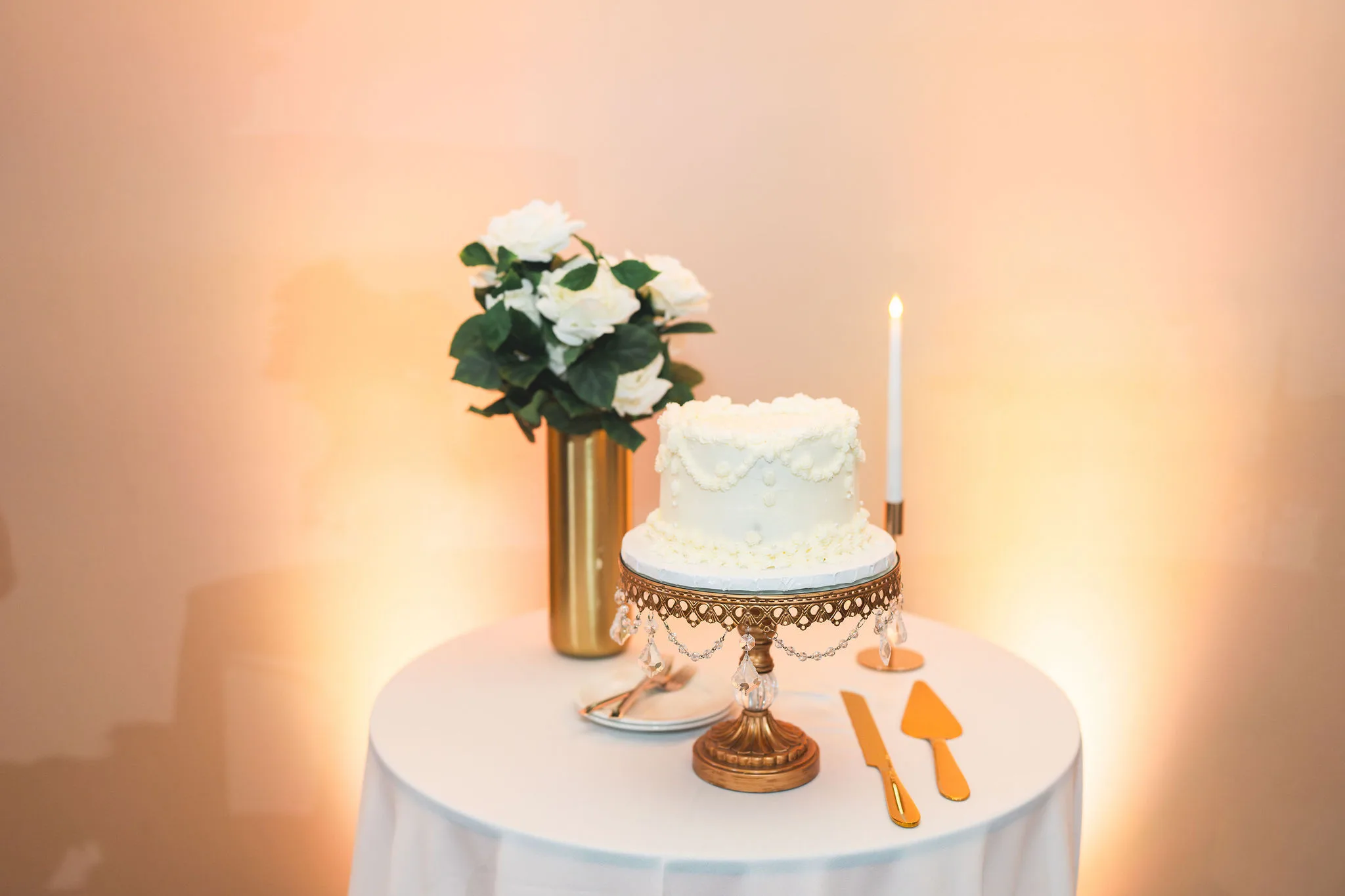 CodyKarinaWedding03.15.2026 858 - European Inspired Wedding | Rollins College White wedding cake on gold pedestal table at european inspired wedding reception