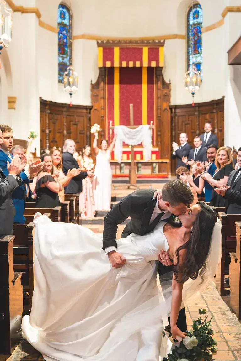 CodyKarinaWedding03.15.2026 635 edited 2 - European Inspired Wedding | Rollins College Groom dipping bride for a kiss inside Knowles Chapel at their european inspired wedding