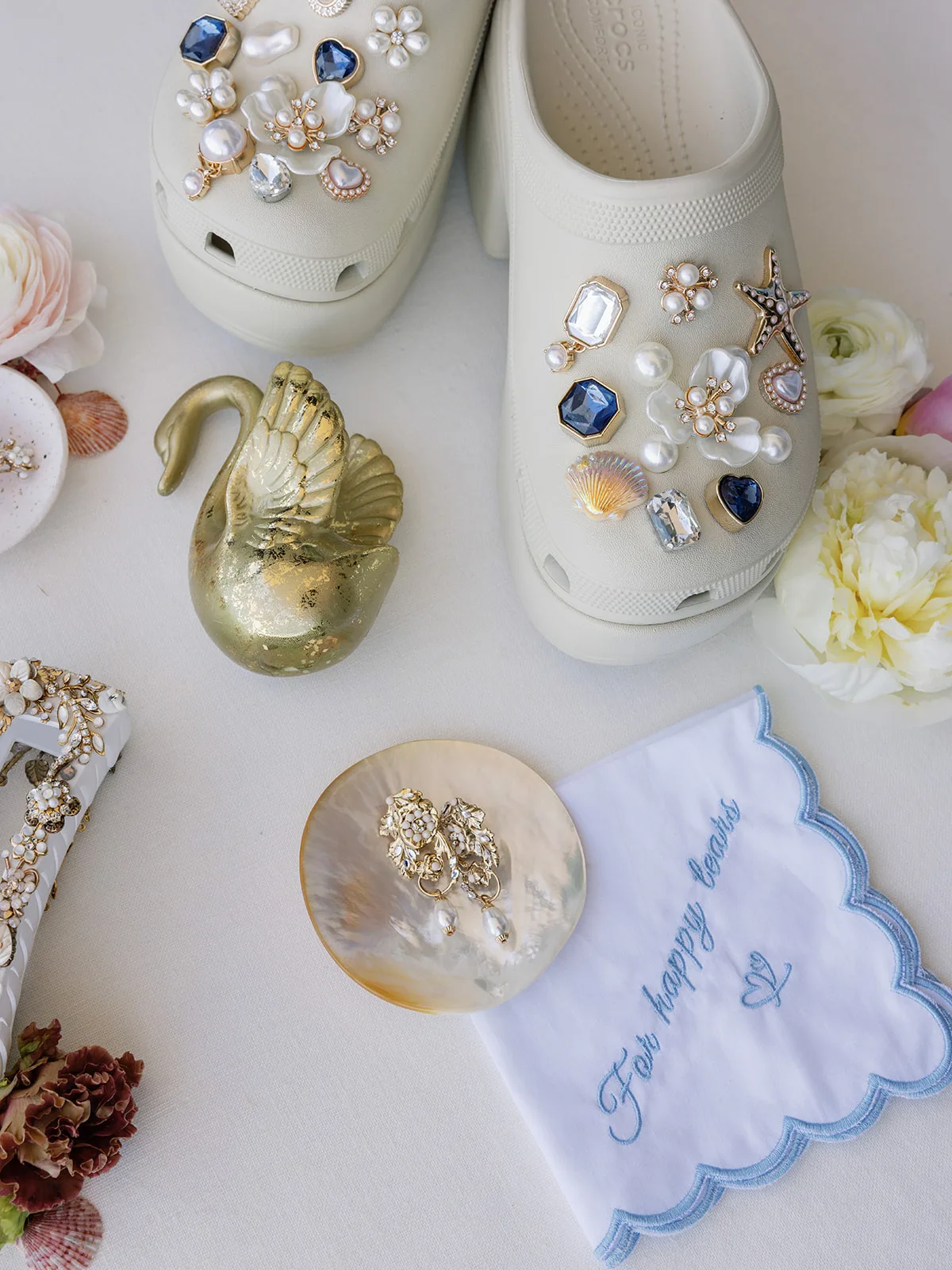BB GR 011 - Romantic Blush and Blue Daytona Beach Wedding Wedding details with jewelry, bridal crocs and napkin