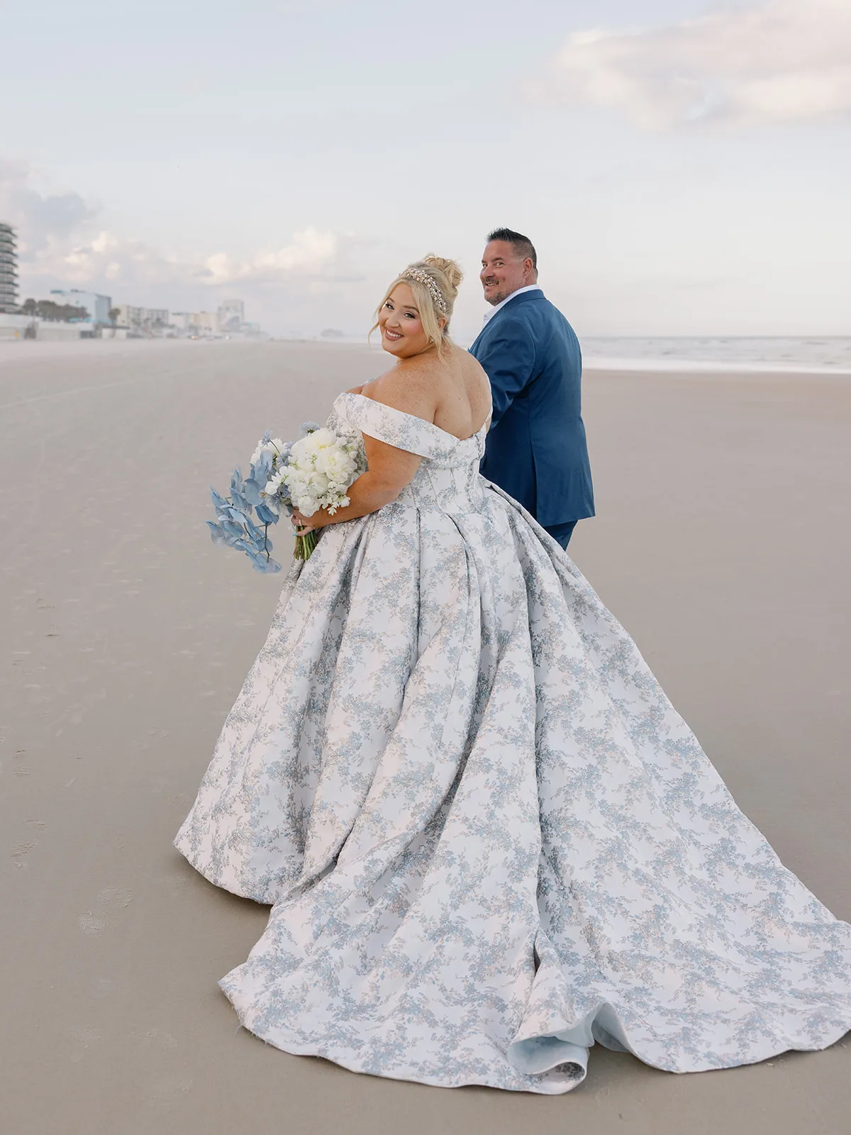 BB Post 092 1 - Romantic Blush and Blue Daytona Beach Wedding Newly married bride and groom walking on the beach