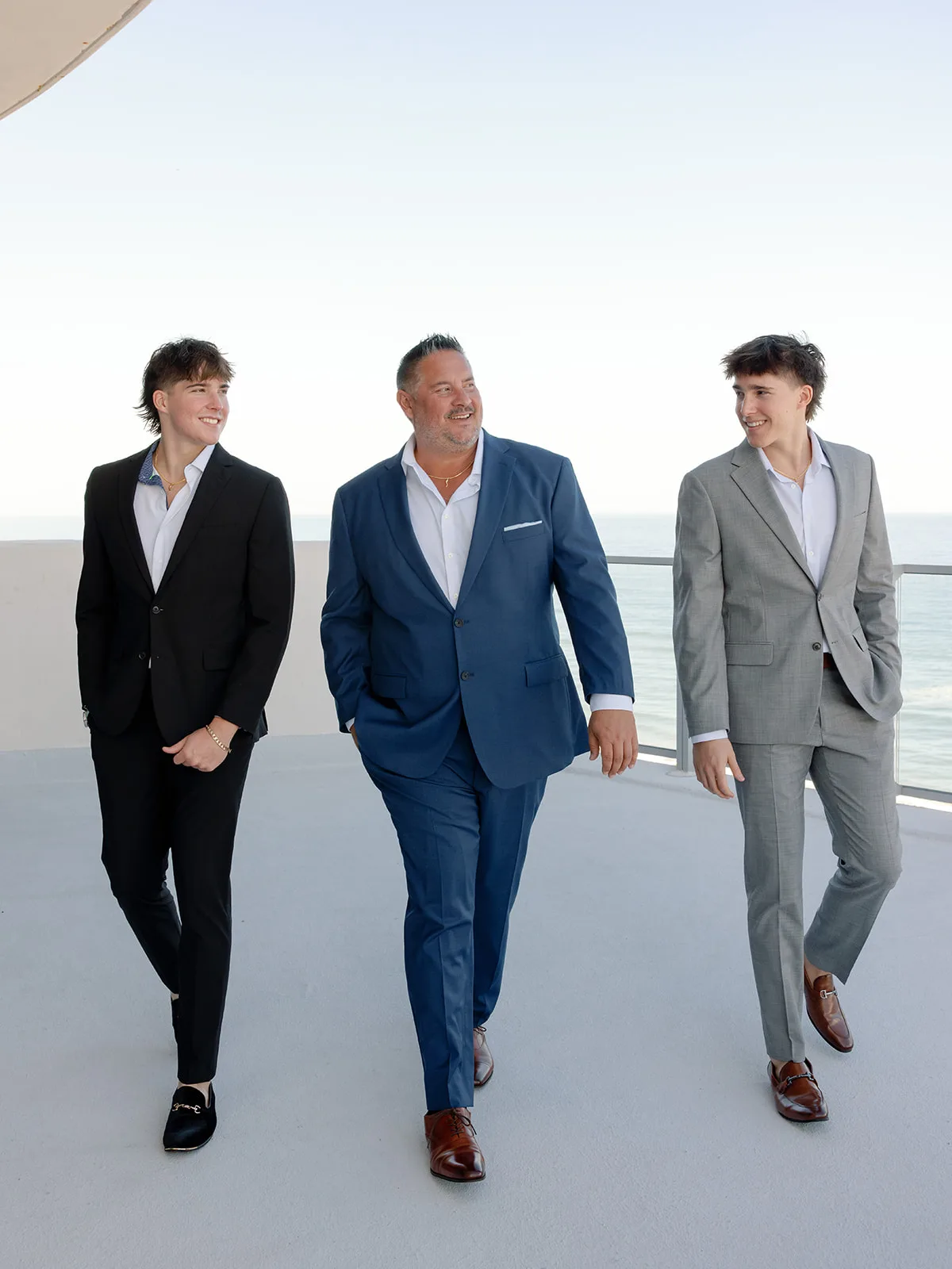 BB Pre 096 - Romantic Blush and Blue Daytona Beach Wedding Groom and groomsmen walking in their suits