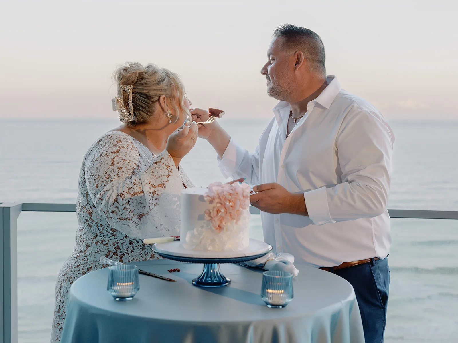 BB Rec 030 - Romantic Blush and Blue Daytona Beach Wedding Bride and groom feeding each other wedding cake
