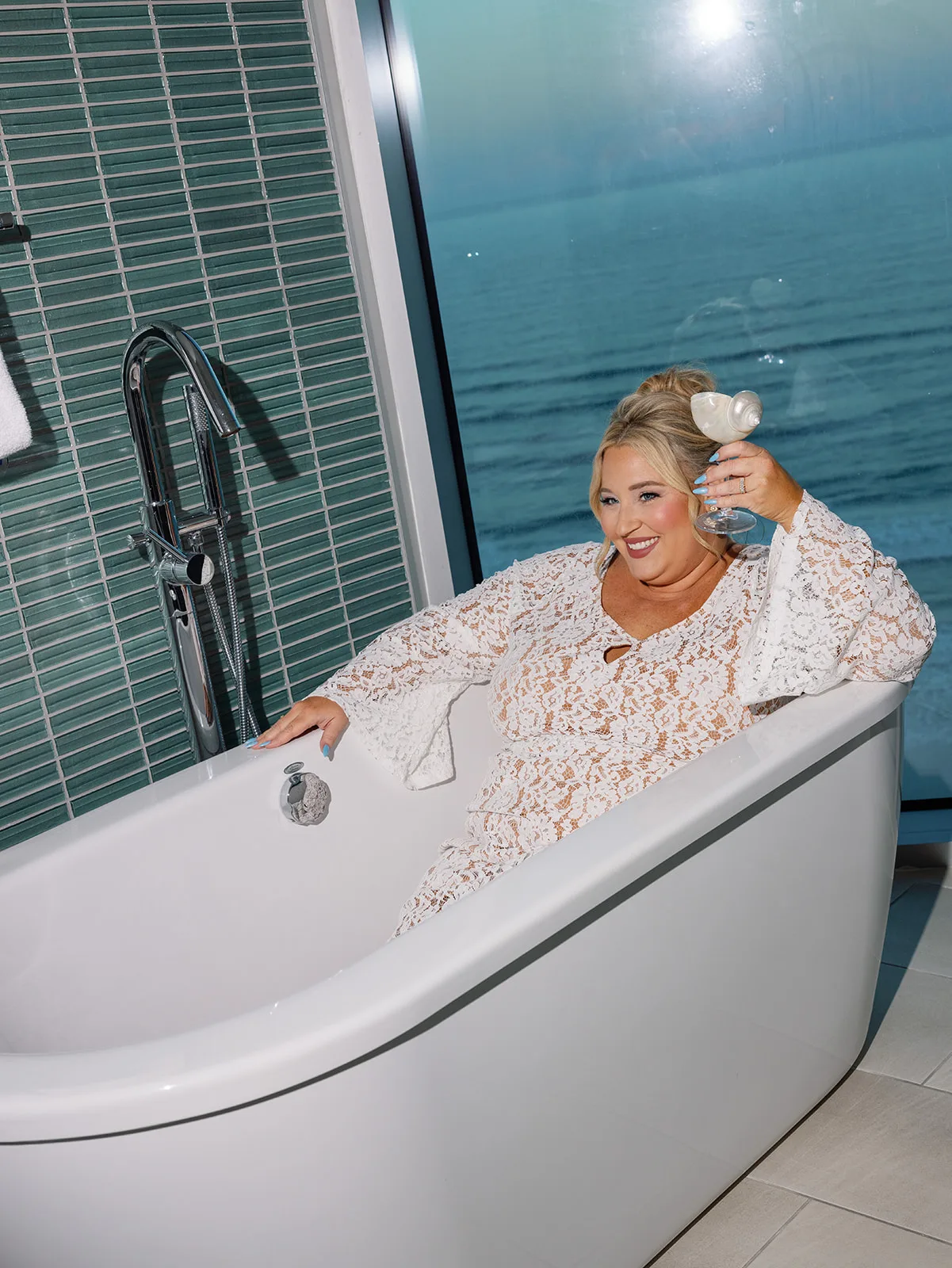 BB Rec 053 - Romantic Blush and Blue Daytona Beach Wedding Bride in tub holding seashell glass