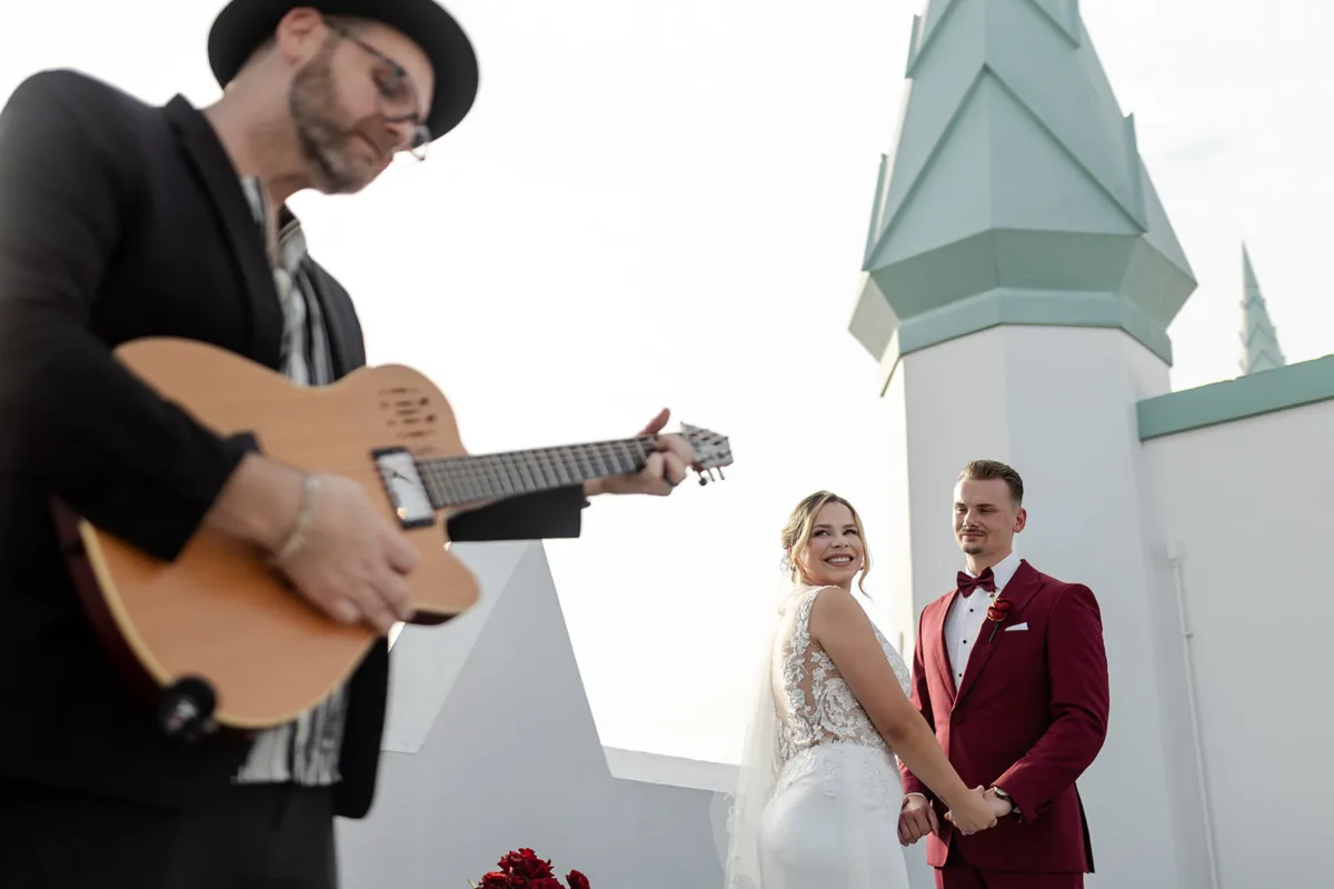Live guitarist performing a custom wedding song during a couple's ceremony