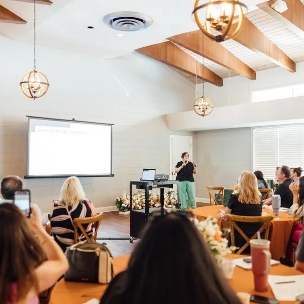 Shannon Tarrant on Stage Speaking to Venue Owners - Your Local Central Florida Wedding Venue & Vendor Guide Shannon Tarrant on Stage Speaking to Venue Owners