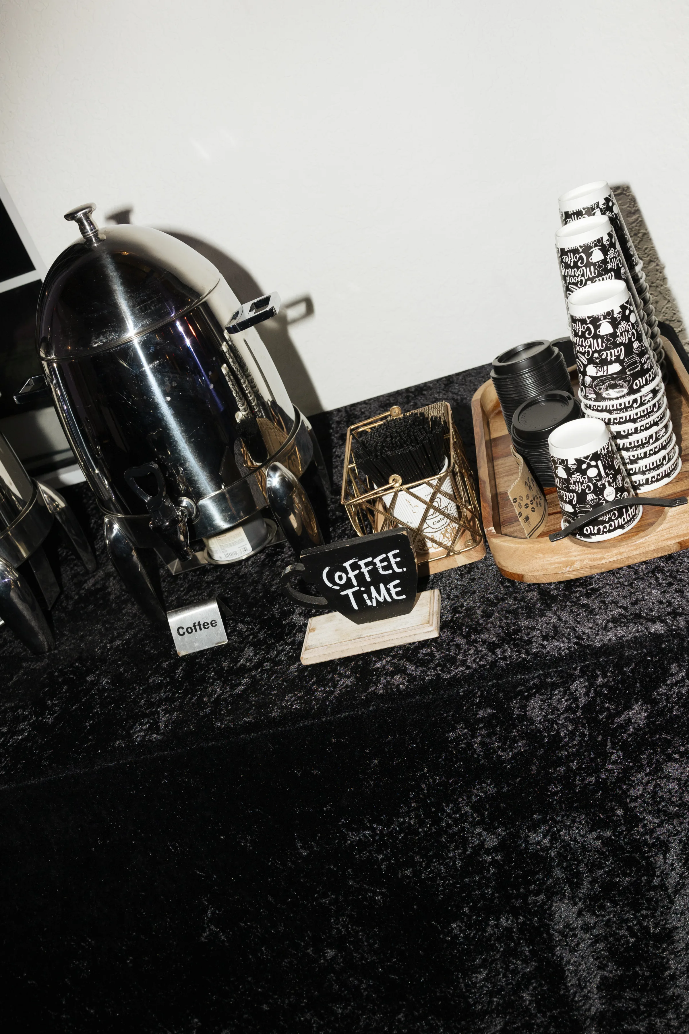 Elegant black and white coffee station with silver urn, decorative cups, and Coffee Time chalkboard sign at a wedding reception in Orlando Florida