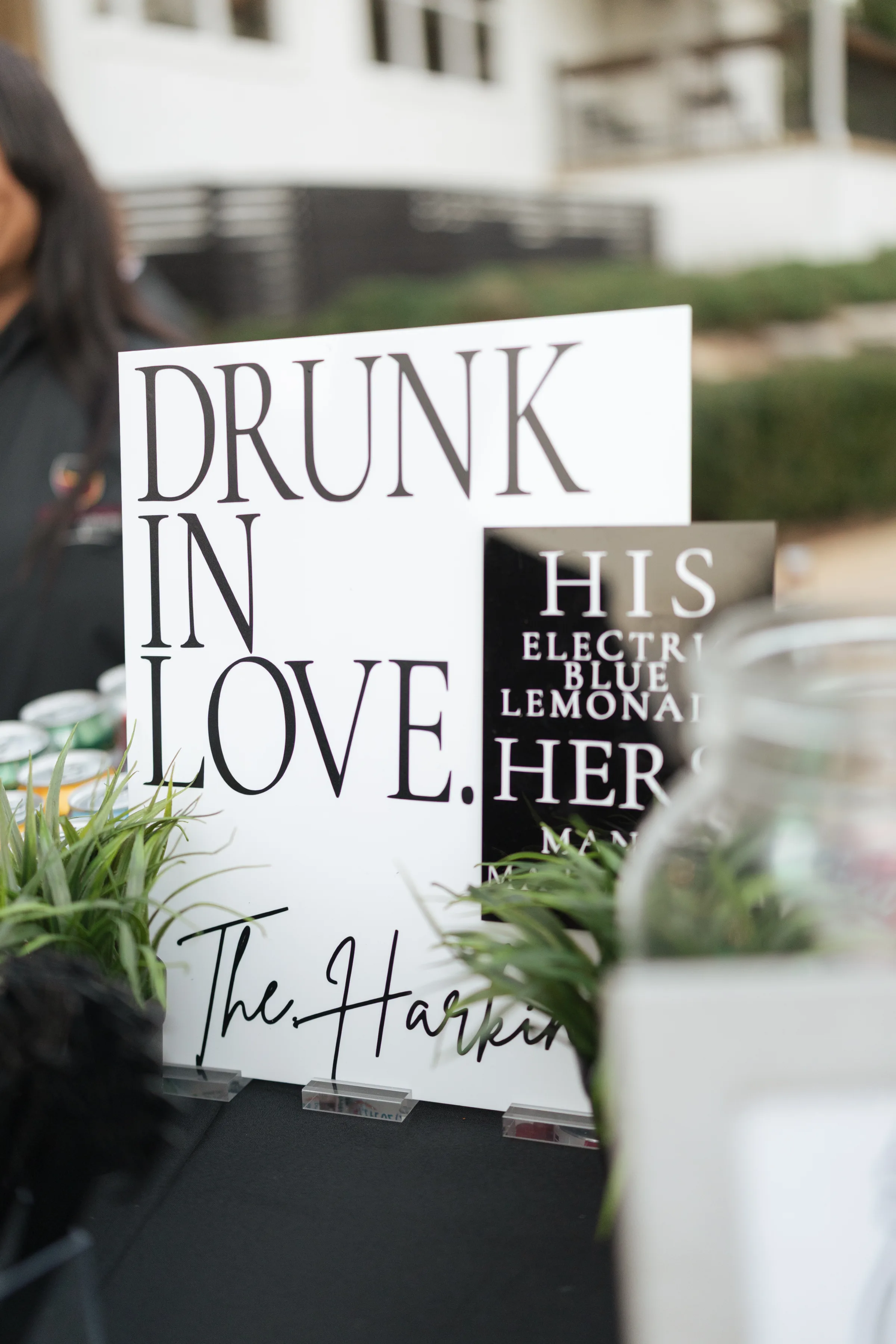 Drunk in Love wedding bar signage for The Harkins with his and hers signature cocktail menu displayed at an outdoor Central Florida wedding reception