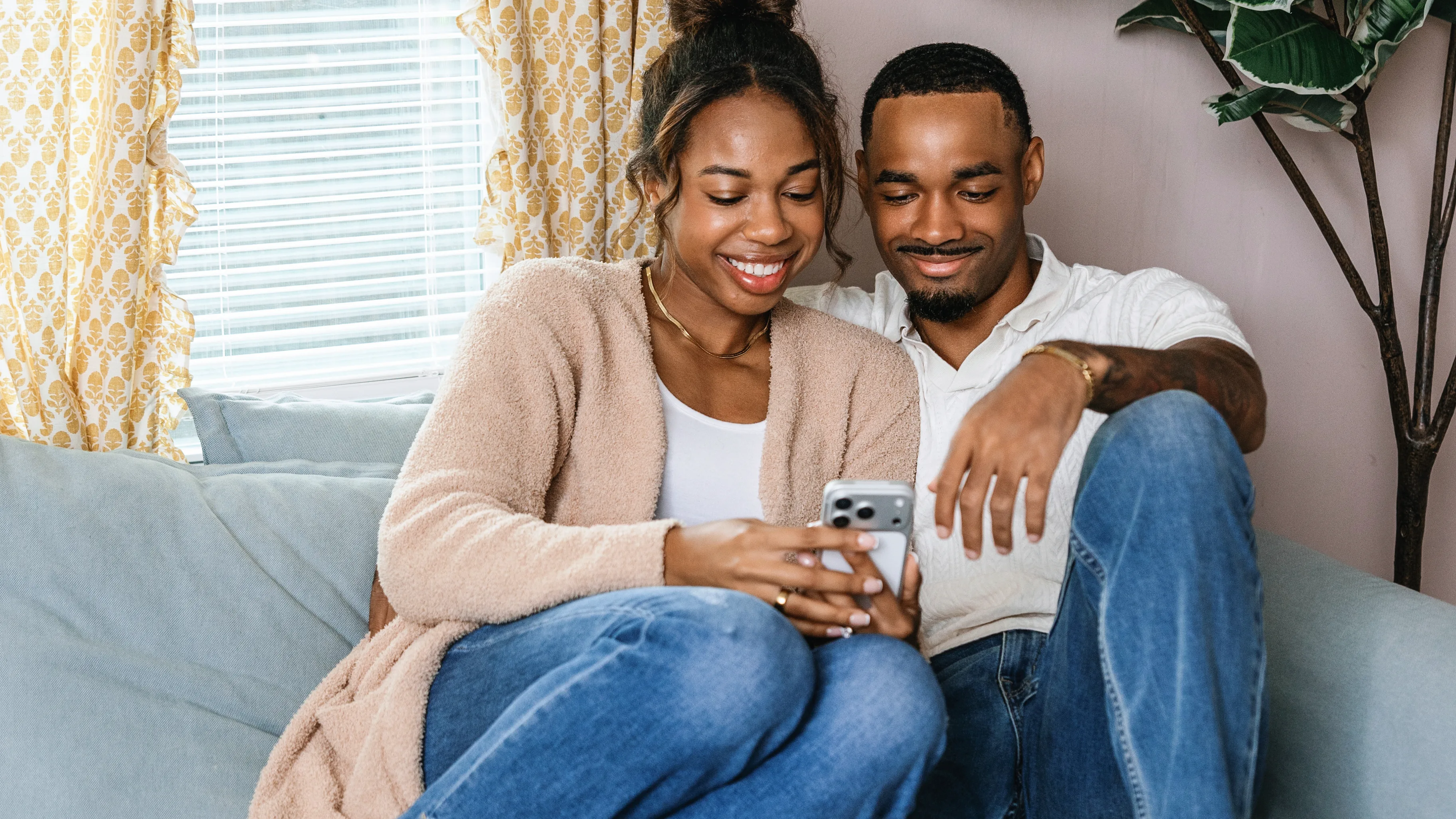 just engaged couple browsing wedding planning ideas edited - Just Engaged? Now What? Newly engaged couple discussing what to do after getting engaged while looking at wedding planning ideas together.