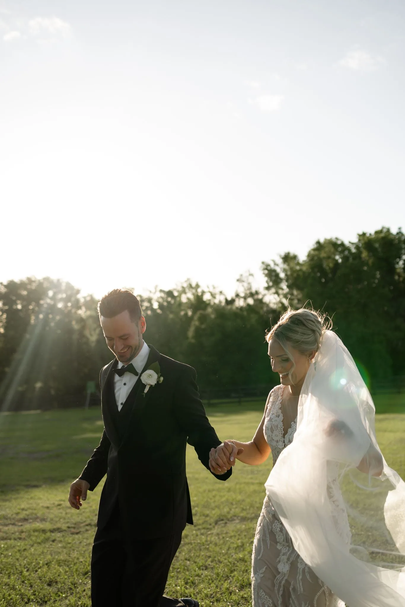 lilac ivory wedding bride groom la hacienda snow hill 2 - An Elegant Lilac and Ivory Wedding at La Hacienda on Snow Hill Bride and groom holding hands and laughing during golden hour portraits at La Hacienda on Snow Hill, an Orlando Central Florida wedding venue, for a lilac and ivory spring wedding celebration