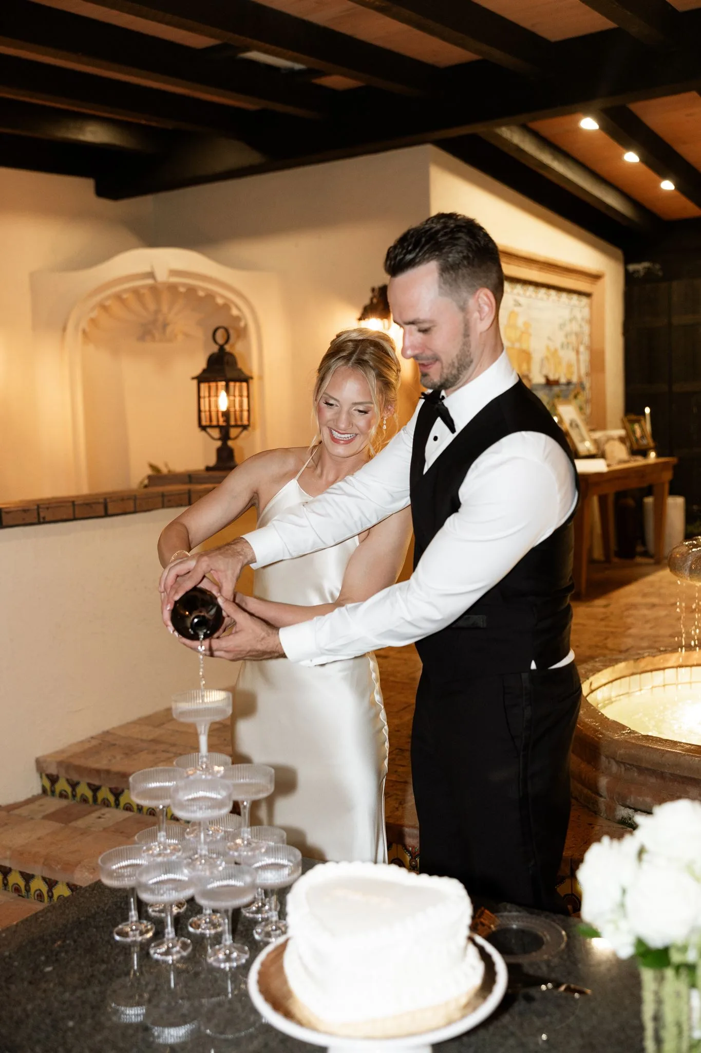lilac ivory wedding champagne tower la hacienda snow hill - An Elegant Lilac and Ivory Wedding at La Hacienda on Snow Hill Bride and groom pouring champagne tower together at their lilac and ivory wedding reception at La Hacienda on Snow Hill in Central Florida