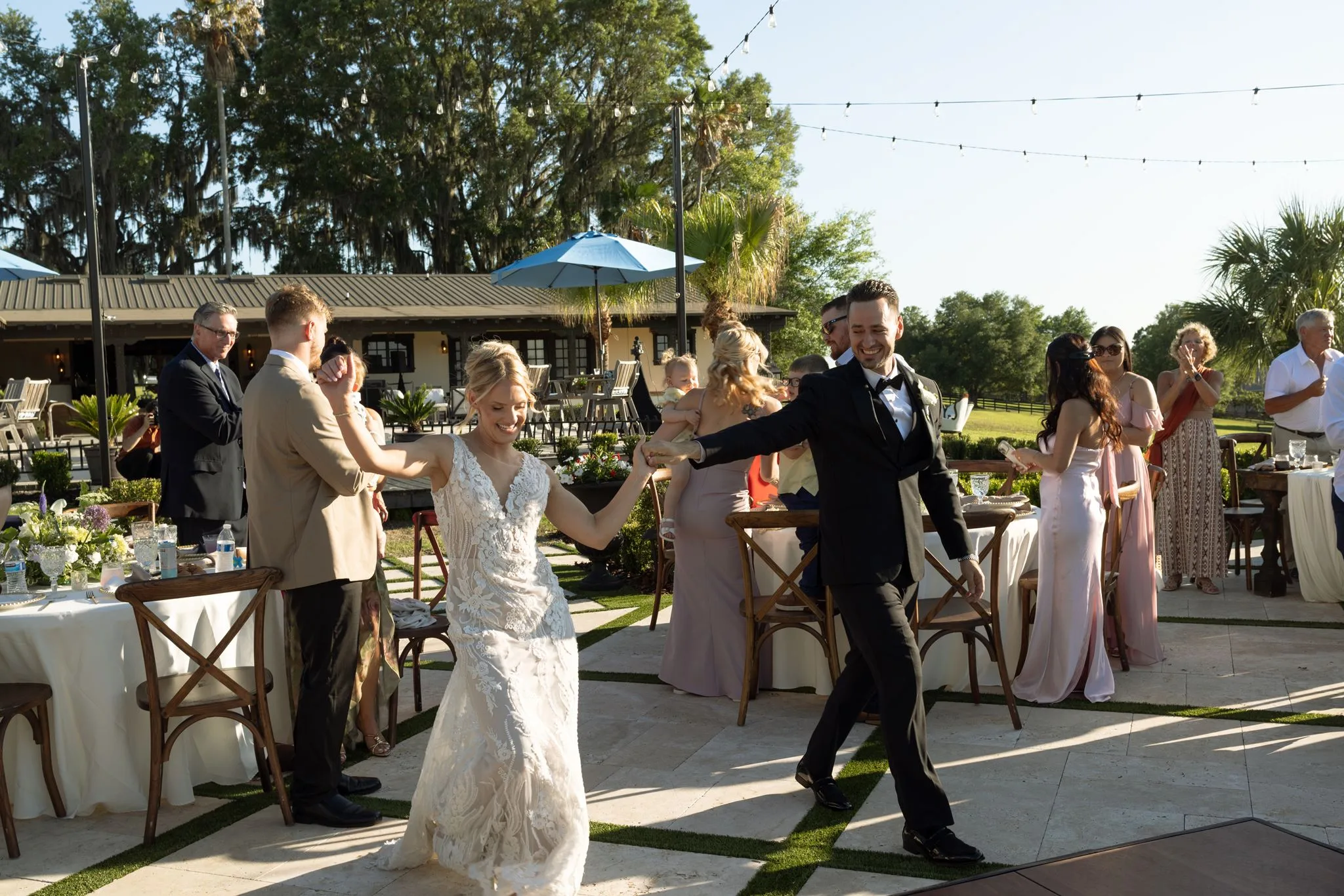 lilac ivory wedding first dance la hacienda snow hill 5 - An Elegant Lilac and Ivory Wedding at La Hacienda on Snow Hill Bride and groom share a joyful first dance at their lilac and ivory outdoor wedding reception at La Hacienda on Snow Hill in Central Florida