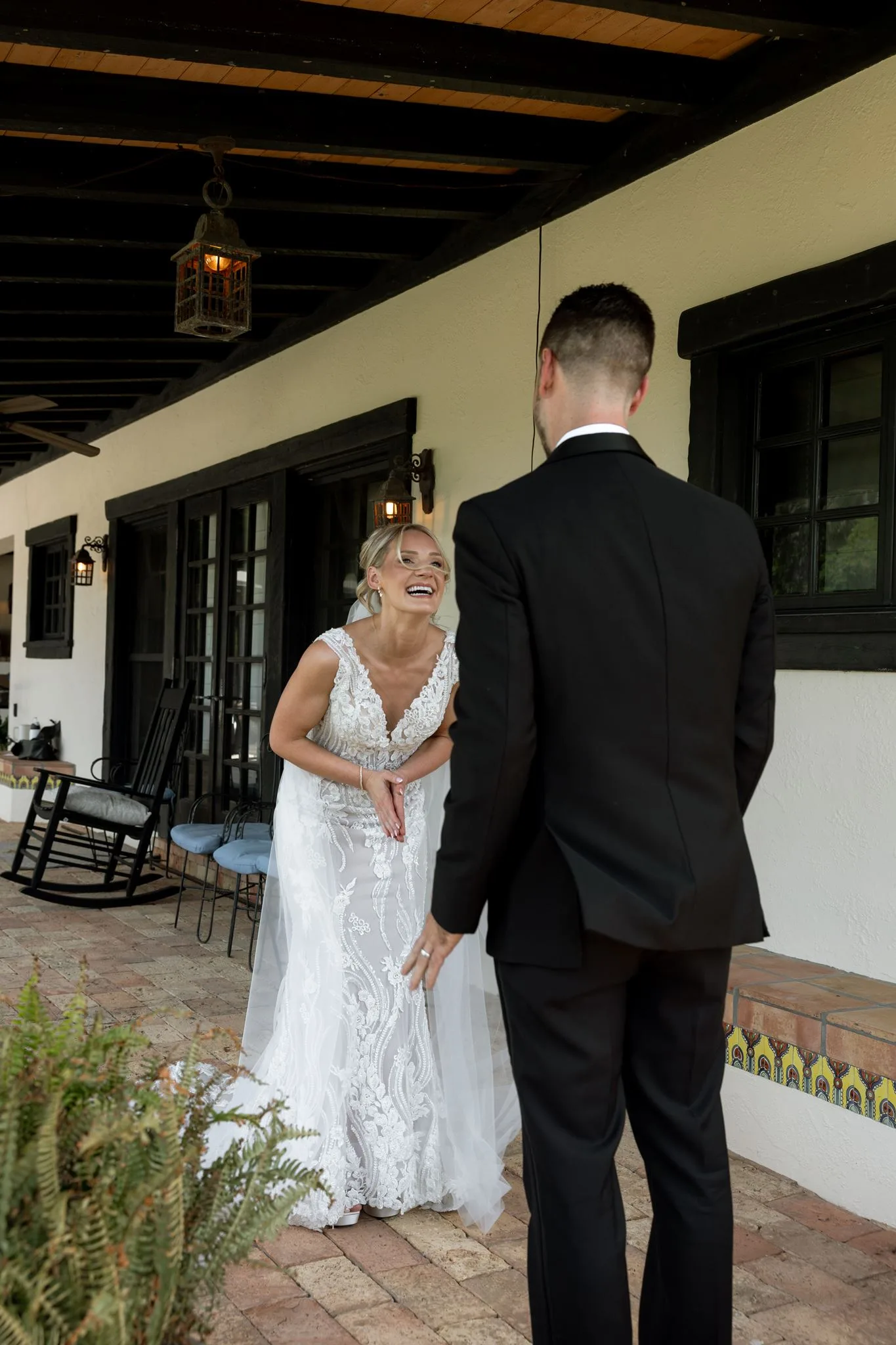 lilac ivory wedding first look la hacienda snow hill - An Elegant Lilac and Ivory Wedding at La Hacienda on Snow Hill Bride in lace gown laughing during first look with groom at La Hacienda on Snow Hill, a lilac and ivory wedding in Central Florida