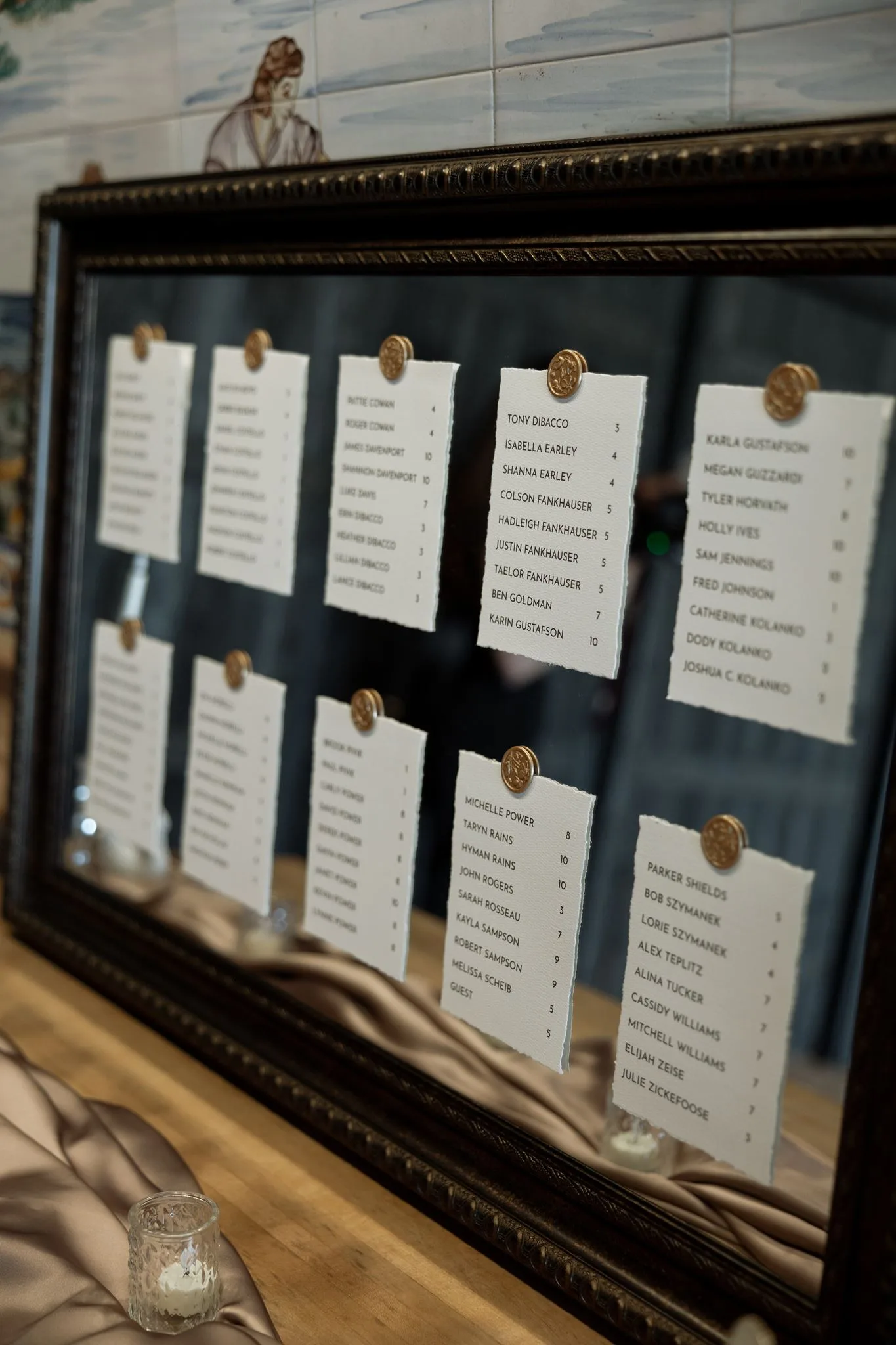 lilac ivory wedding seating chart la hacienda snow hill - An Elegant Lilac and Ivory Wedding at La Hacienda on Snow Hill Elegant gold wax seal escort card display on ornate mirror frame for a lilac and ivory wedding at La Hacienda on Snow Hill in Orlando Florida